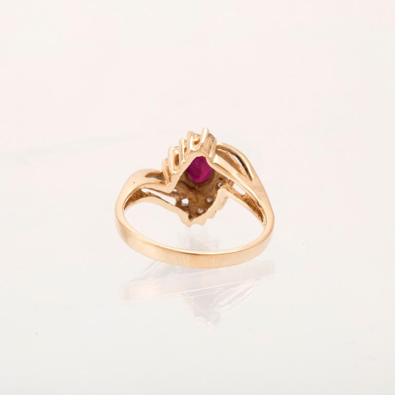 A 14K gold ring set with an oval faceted synthetic ruby and round brilliant-cut diamonds.