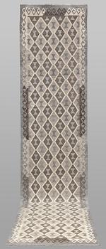 A Kilim runner carpet. 393 x 89 cm.