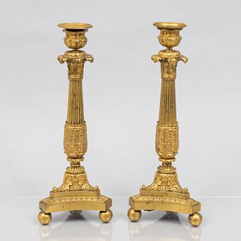 A pair of French Empire gilt-bronze candlesticks, early 19th century,