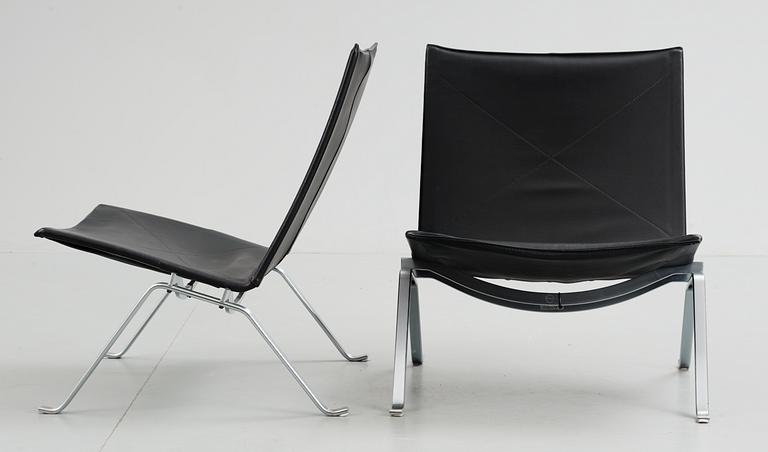 A pair of Poul Kjaerholm 'PK-22' steel and black leather easy chairs, Fritz Hansen, Denmark 1992.