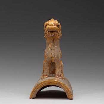 A yellow glazed roof tile figure of a Buddhist lion, Ming dynasty (1368-1644).