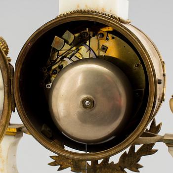 A Louis XVI marble and bronze mantel clock from the second half of the 18th century.