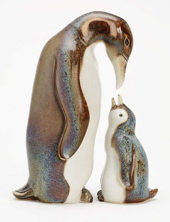 Two Gunnar Nylund stoneware figures depicting a penguin mother with child, Rörstrand.