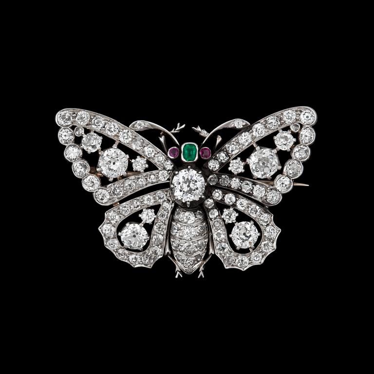 A emerald, ruby and old european cut diamond app. tot. 5 cts brooch in the shape of a butterfly.