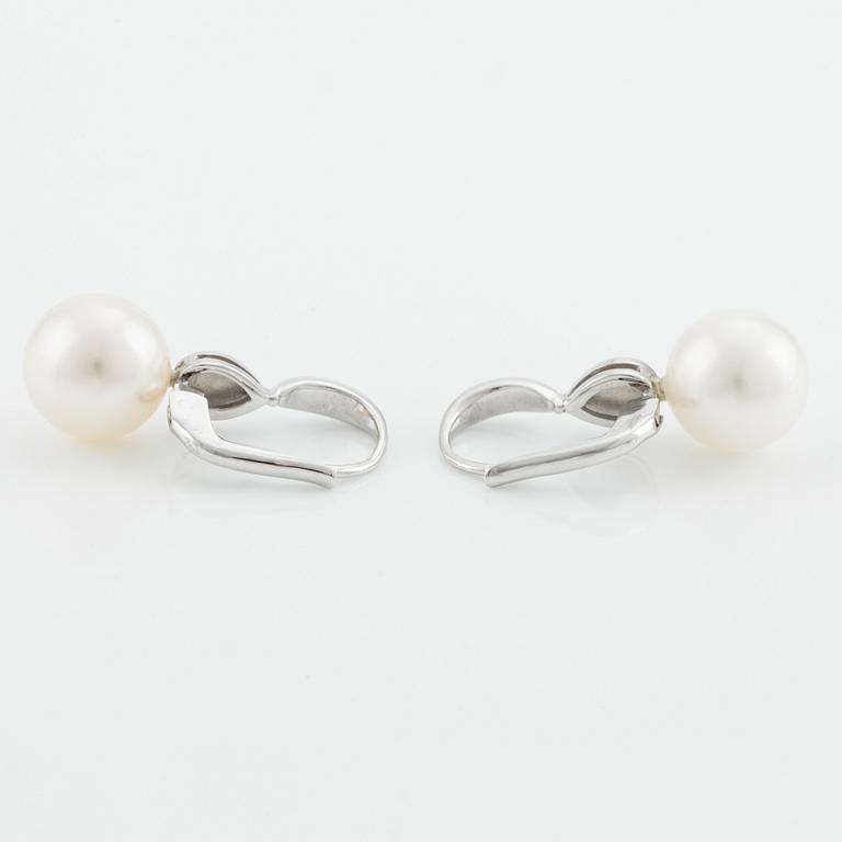 A pair of cultured pearl and brilliant cut diamond earrings.