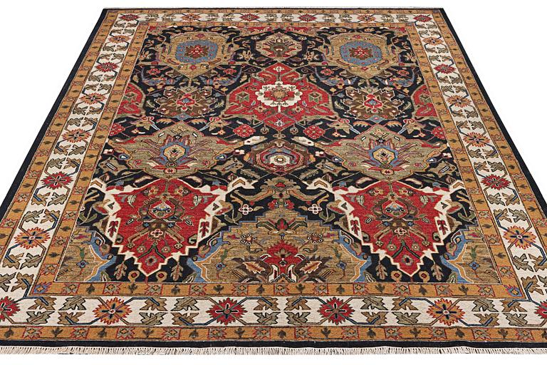 An oriental carpet with Mamluk design, c. 364 x 276 cm.