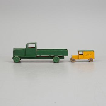 A set of two wooden toy trucks.