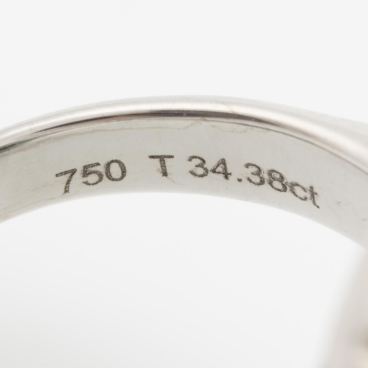 Ring, cocktail ring, 18K white gold with a large cabochon-cut green tourmaline and trapeze-cut diamonds.