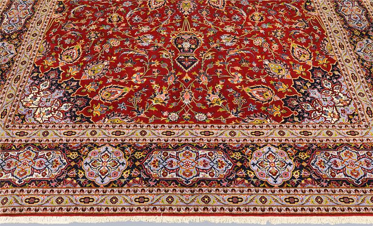 A Keshan carpet, part silk, signed, approx. 398 x 270 cm.