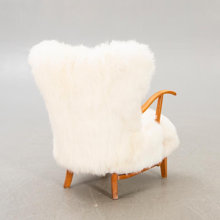A 1940s sheepskin armchair.