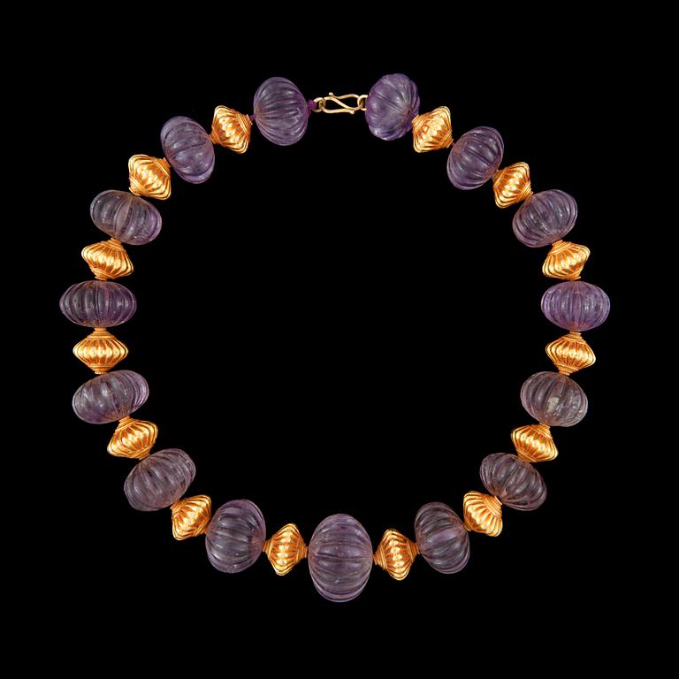 A carved amethyst bead necklace.
