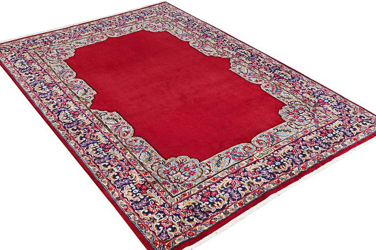 An old Kerman carpet, signed, c. 290 x 208 cm.