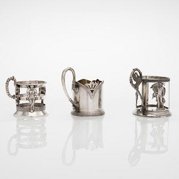 Three silver tea glass holders, 2XA-artel in St. Petersburg, and Odessa and Moscow, late 19th and early 20th centuries.