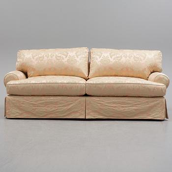 A sofa upholstered with silk damask.