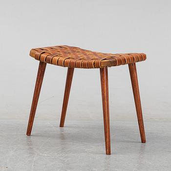 A leather upholstered stool, 1950's.