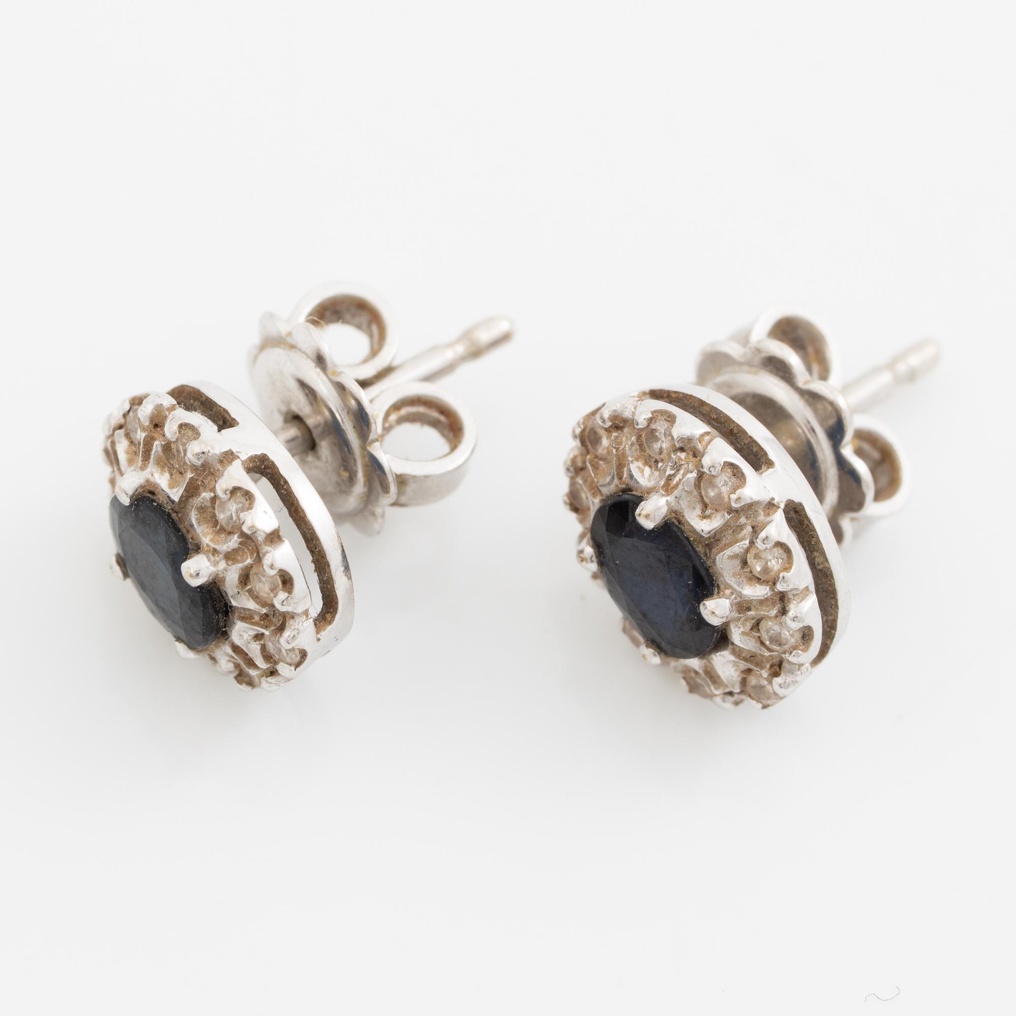 Earrings, a pair of 18K white gold set with dark sapphires and small brilliant-cut diamonds.
