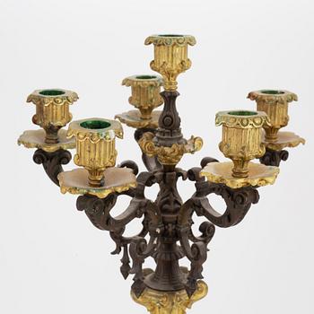 A pair of patinated bronze and ormolu neo-renaissance six-light candelabra, later part of the 19th Century.