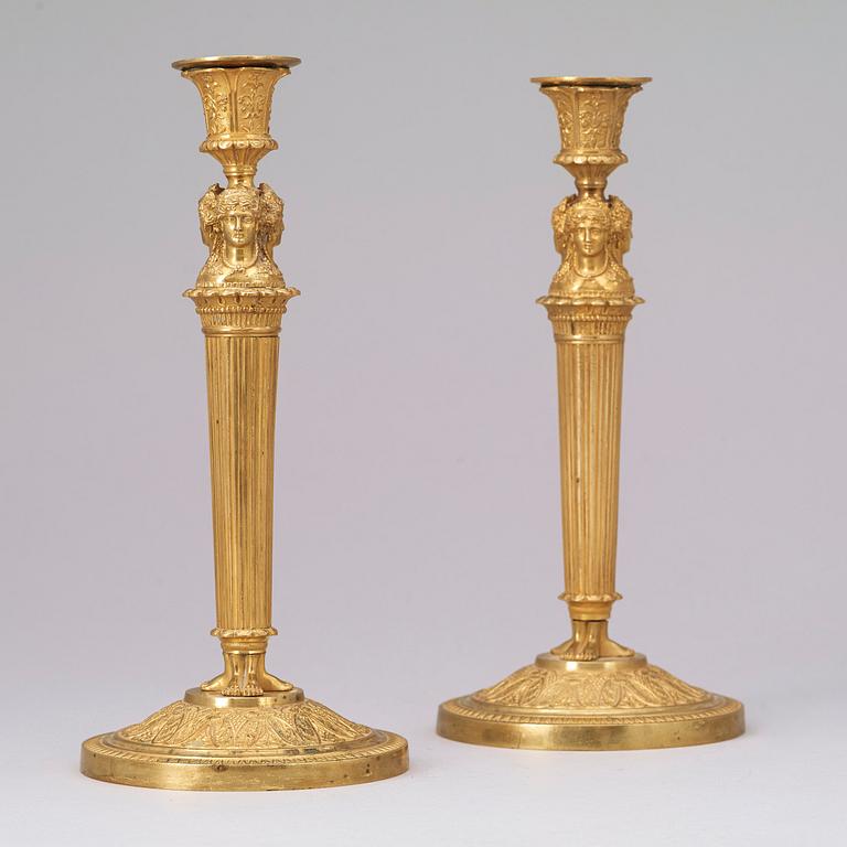 A pair of French Empire early 19th century gilt bronze candlesticks.