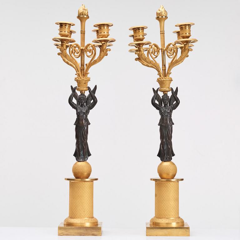 A pair of Empire four light candelabra.