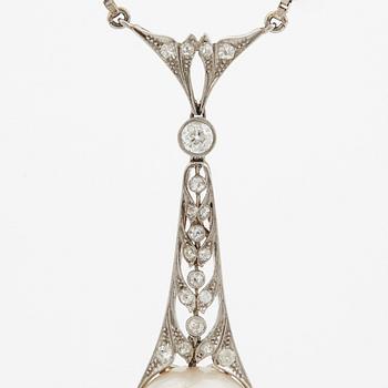 A platinum pendant set with a half pearl and old-cut diamonds.