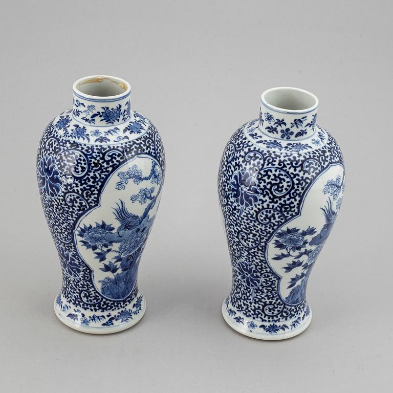 A pair of blue and white vases, Qing dynasty, late 19th century, with a Kangxi mark to the base.