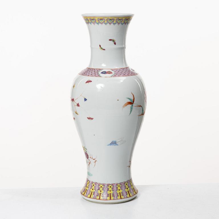 A slender famille rose 'flowers and antiques' vase, late Qing dynasty/early 20th century.
