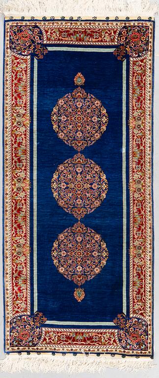 A rug, silk Hereke, ca 143 x 63,5 cm.