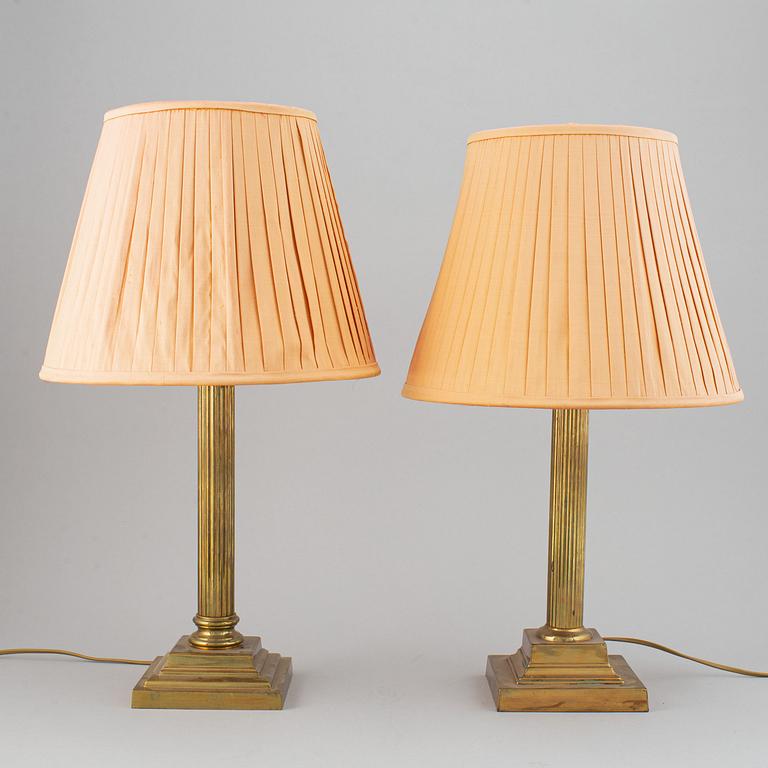 A pair of 20th century brass Empire style table lamps.