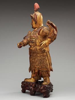 A lacquered and gilt wooden figure of a warrior, Qing dynasty, ca 1800.