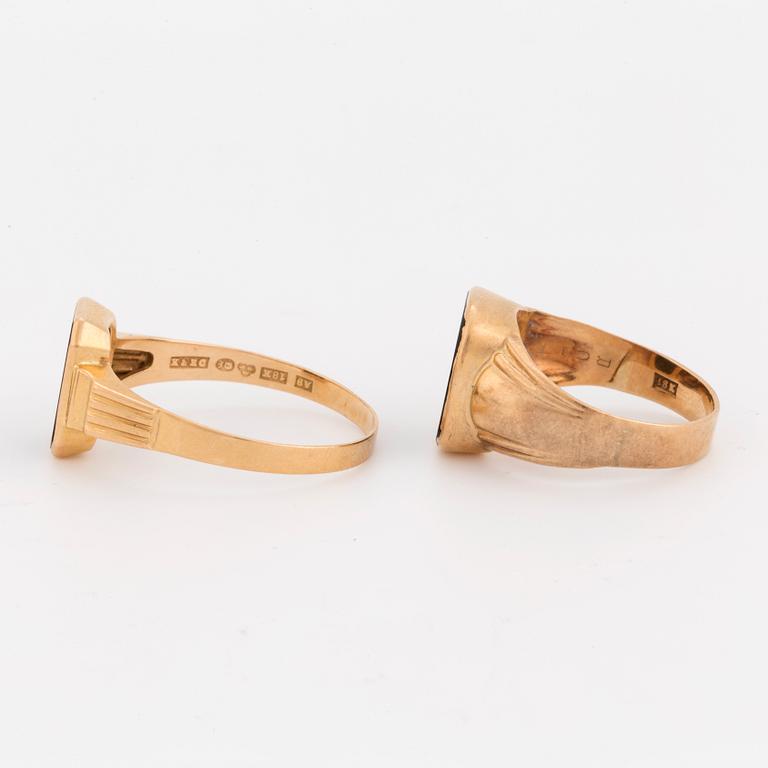 Two 18K gold signet rings set with onyx.