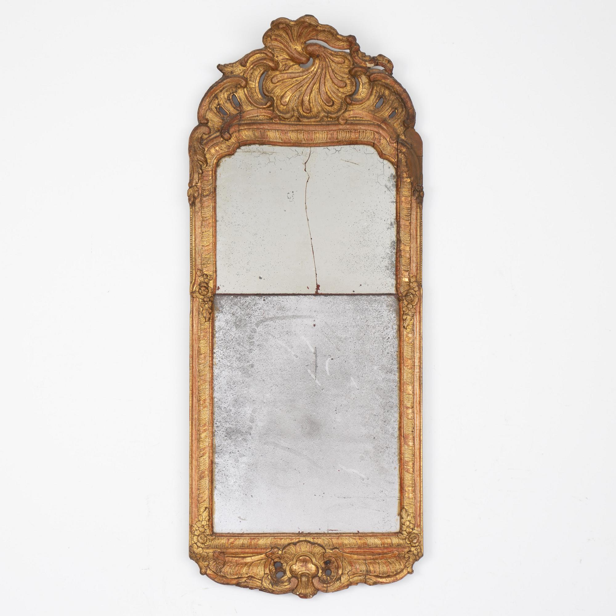 A Swedish rococo giltwood mirror in the manner of E. Göbel, Stockholm, later part 18th century.
