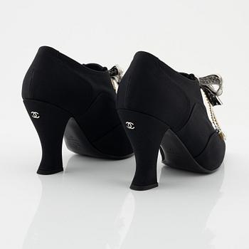 Chanel, a pair of peal and strass bow pumps, size 37.