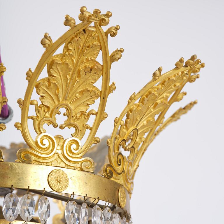 An French Empire eight-light gilt-brass and cut-glass chandelier.