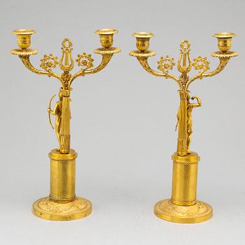 A pair of French Empire two-light gilt bronze candelabra, early 19th century.