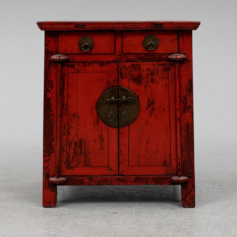 A red lacqured Chinese cabinet, 20th Century.