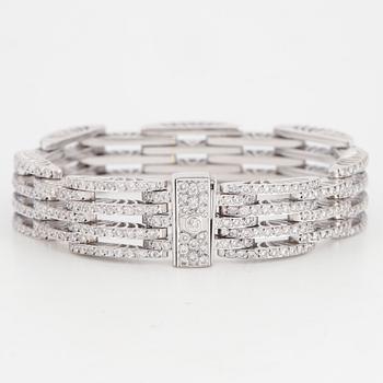 An 18K white gold bracelet set with round brilliant-cut diamonds.