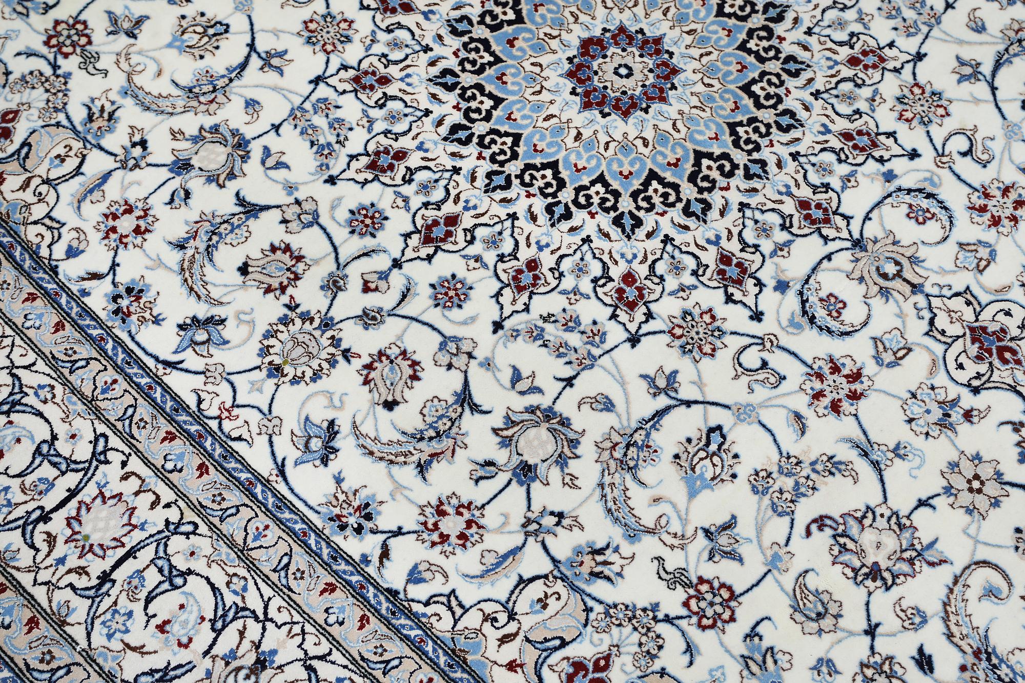 A Nain carpet, part silk, so called 6LAA, approximately 279 x 200 cm.