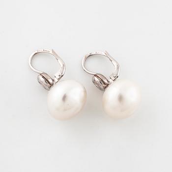 A pair of cultured pearl and brilliant cut earrings.