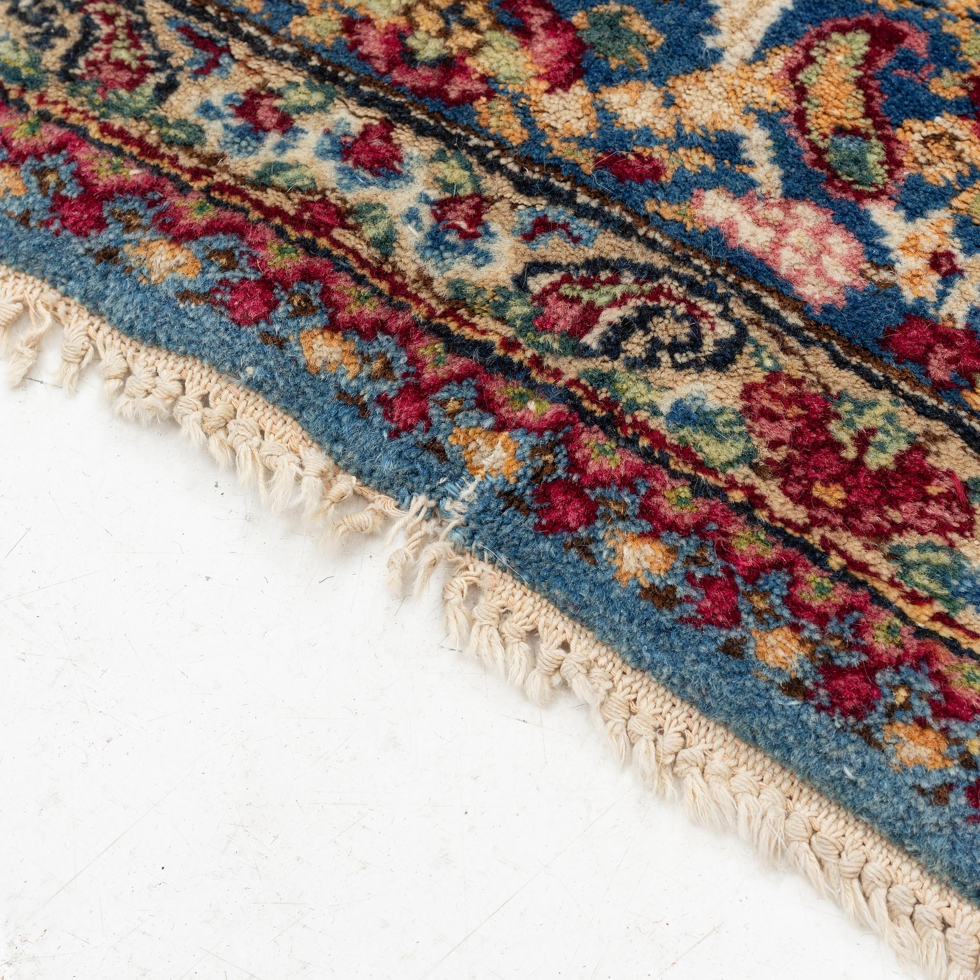 A Persian rug, c. 220 x 140 cm.