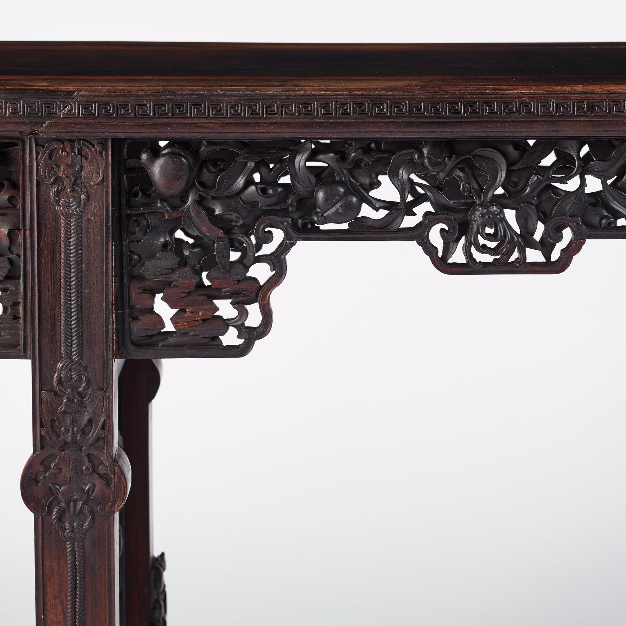 A massive zitan recessed-leg long table 'Jiaotousun Qiotouan', Qing dynasty, 19th century.