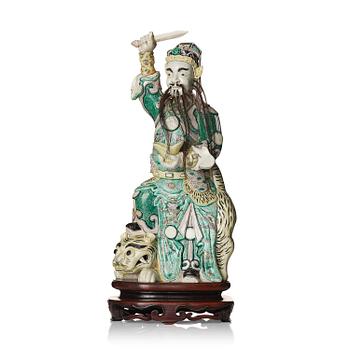 1056. A famille verte bisquit figure of a warrior, Qing dynasty, 19th century.