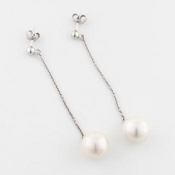 A pair of cultured pearl earrings.