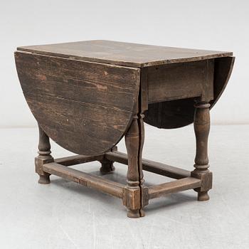 A Baroque-style gate leg table, 19th century.