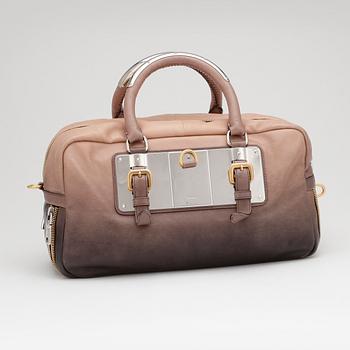 PRADA, a brown leather top handle bag.