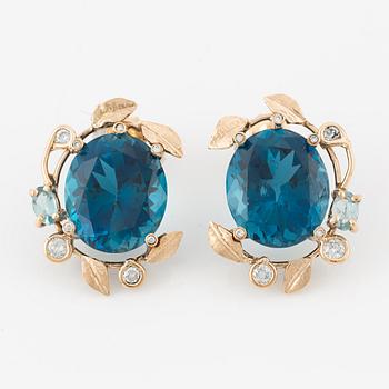 Earrings with blue topazes and brilliant-cut diamonds.