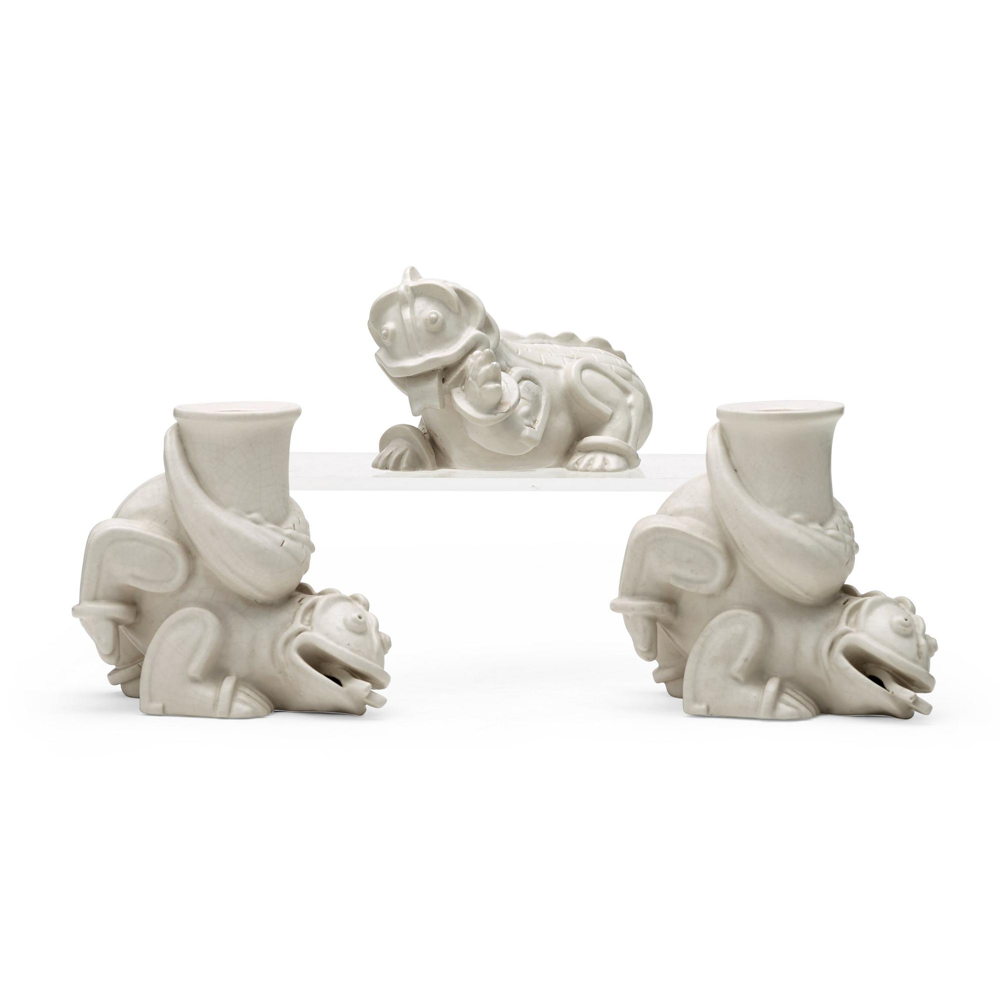 Wilhelm Kåge, a set of stoneware figures of a 'dragon puppy' and two 'dragon puppies' with candle holders, Gustavsberg, ca 1940.