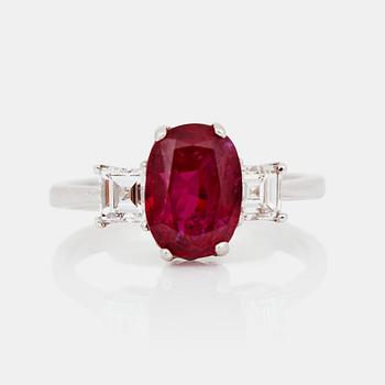 701. A 3.164 ct Burmese untreated 'Pigeon Blood-red' ruby, flanked by two step-cut diamonds.