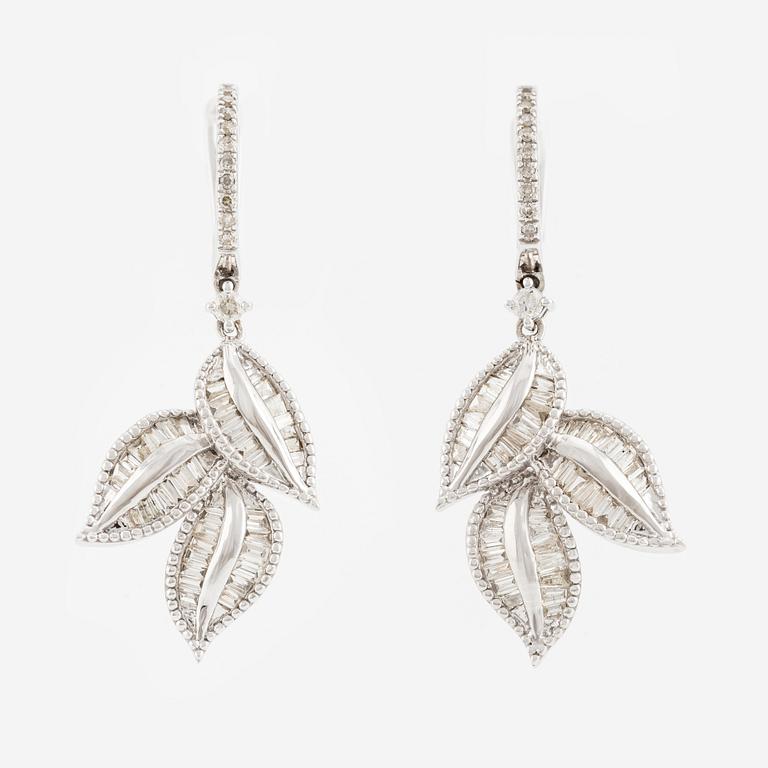 A pair of 14K gold earrings with baguette-cut diamonds.