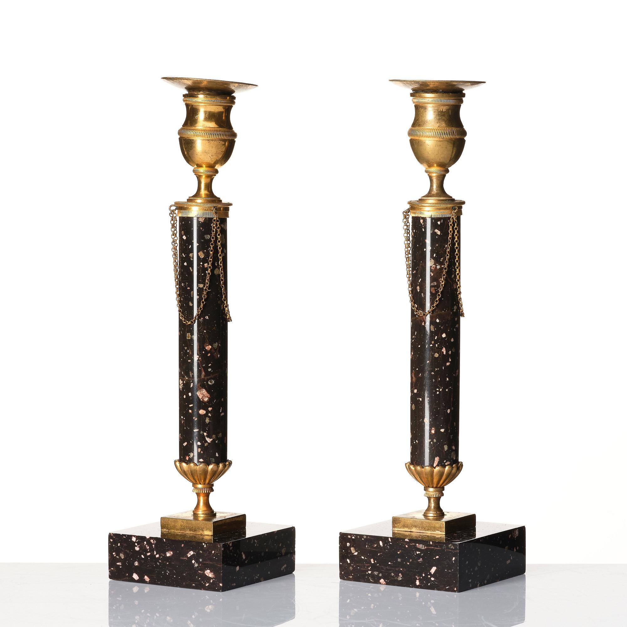 A pair of late Gustavian porphyry and gilt brass candlesticks, circa 1800.