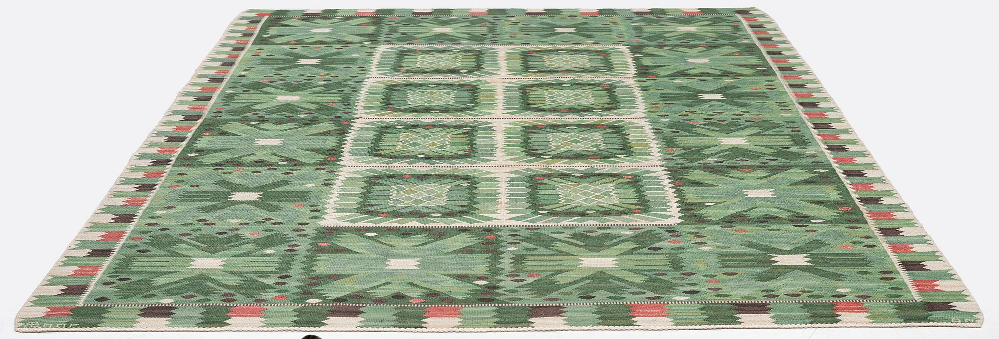 Barbro Nilsson, a carpet 'Nejlikan grön', flat weave, c. 390 x 278 cm, signed AB MMF BN.